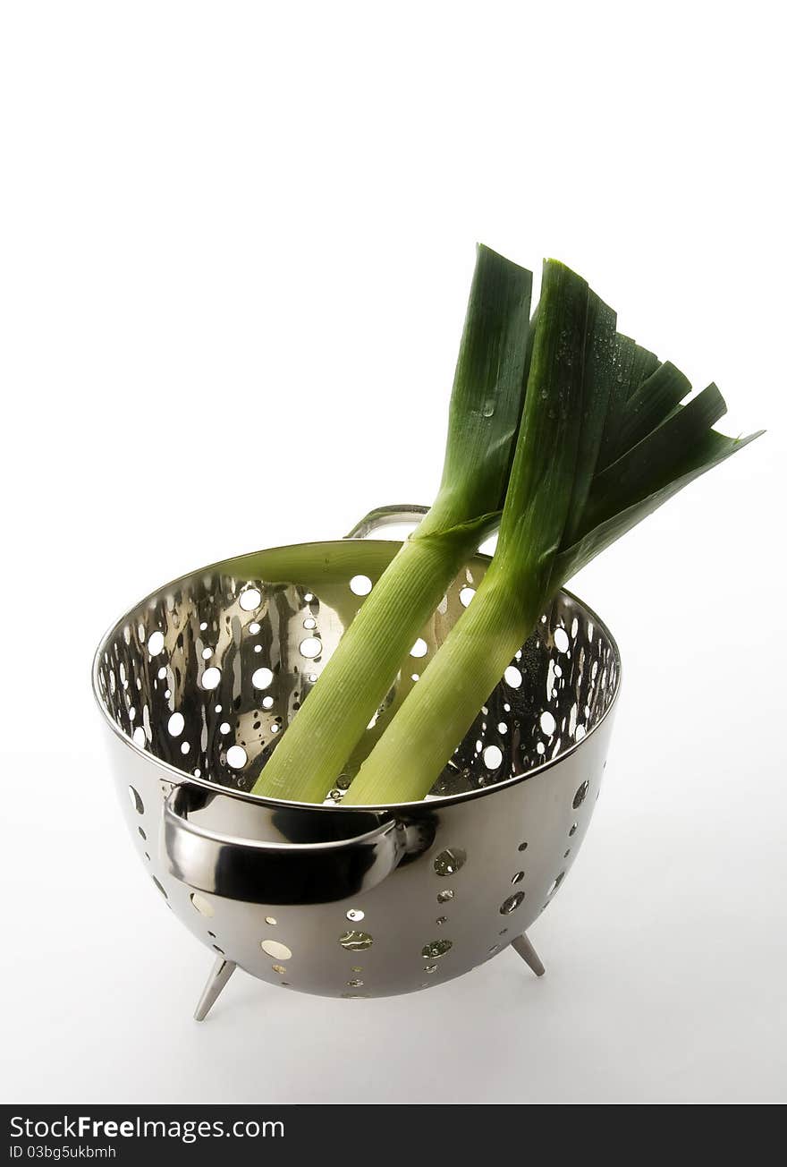 Two healthy, nutritious looking leeks in a collander ready for cooking