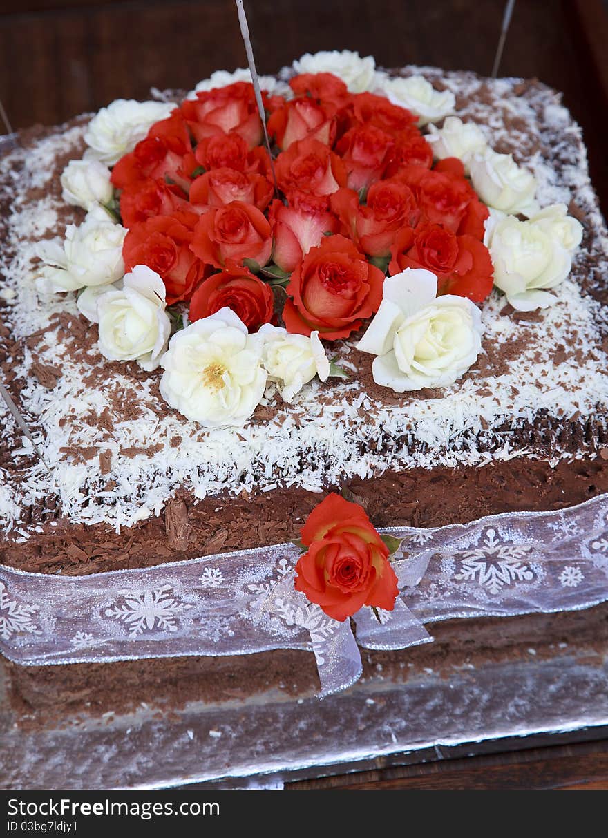 Yummy cake decorated with white and red flowers