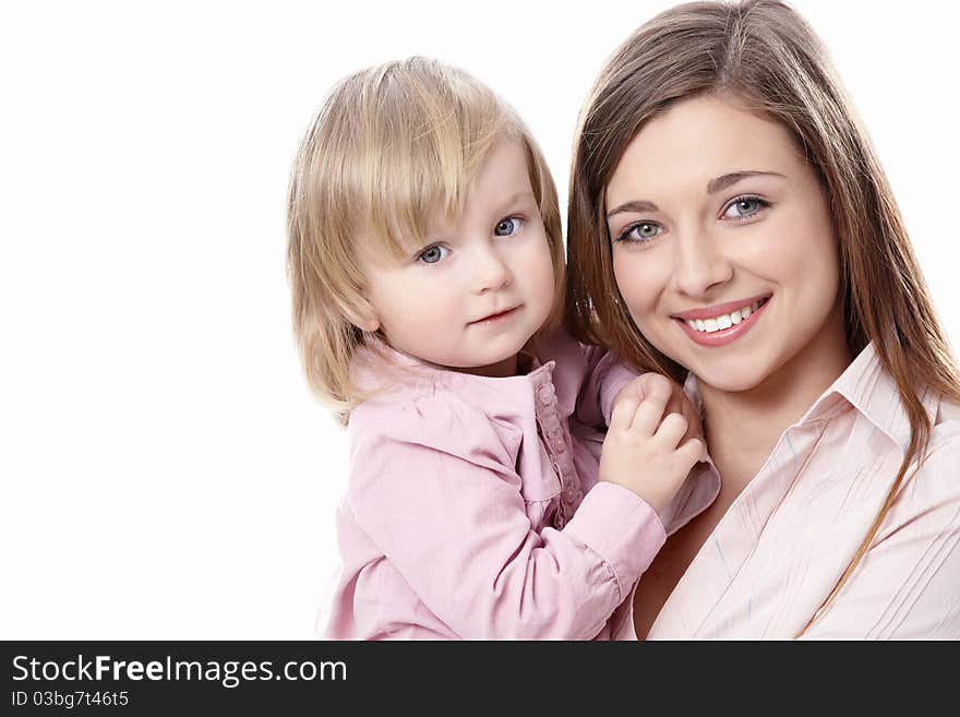 Young mother with her daughter in her arms on a white background. Young mother with her daughter in her arms on a white background