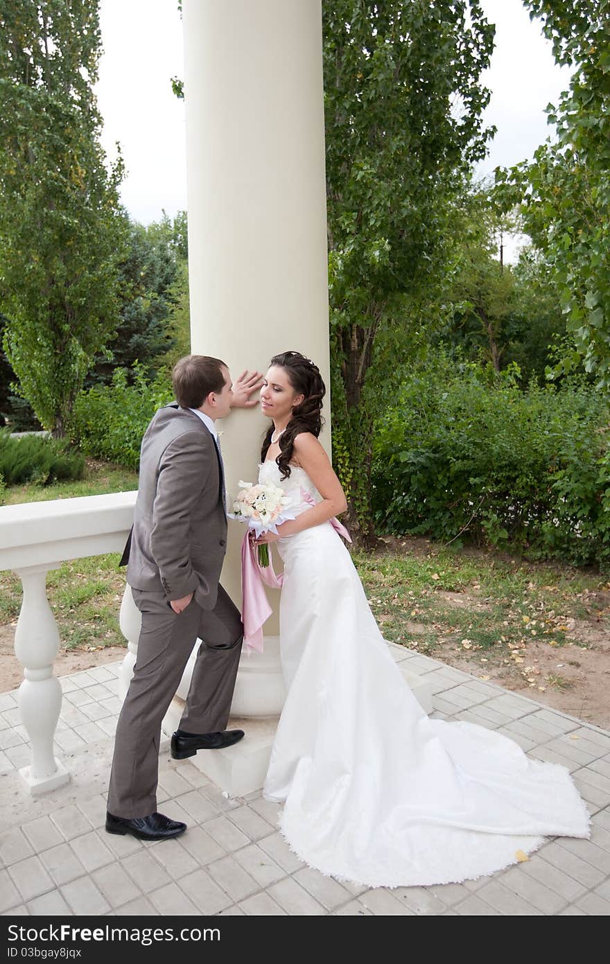 Bride and groom near the column. Bride and groom near the column