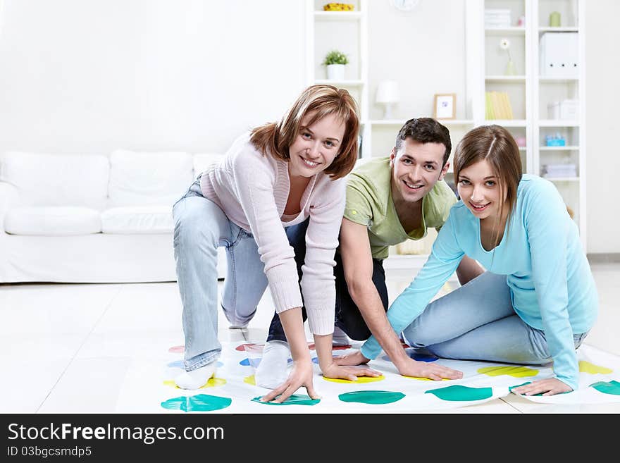 Attractive young people play Twister. Attractive young people play Twister