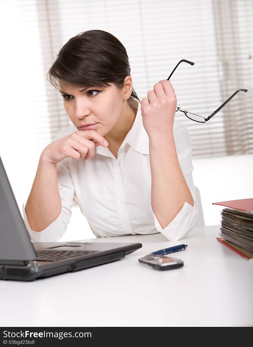 Young adult over-worked woman at desk