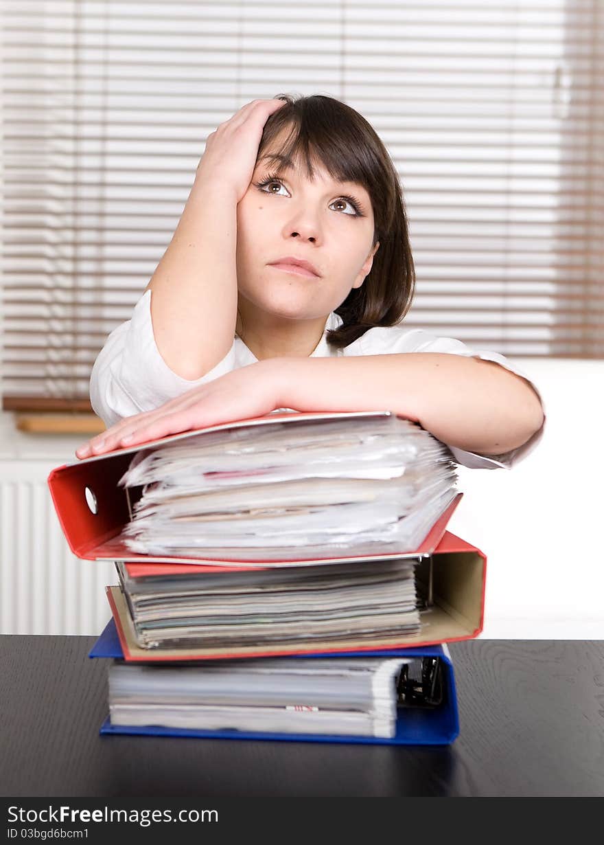 Young adult over-worked woman at desk