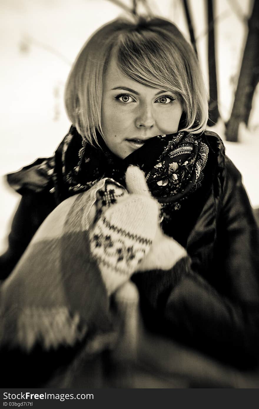 Frozen beautiful woman in winter clothing outdoors