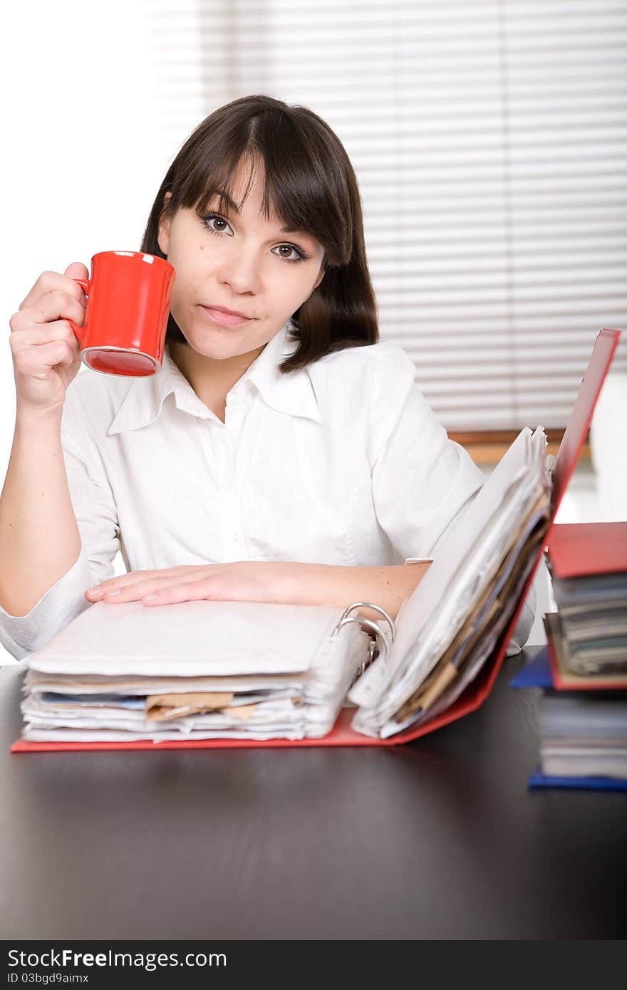 Young adult over-worked woman at desk