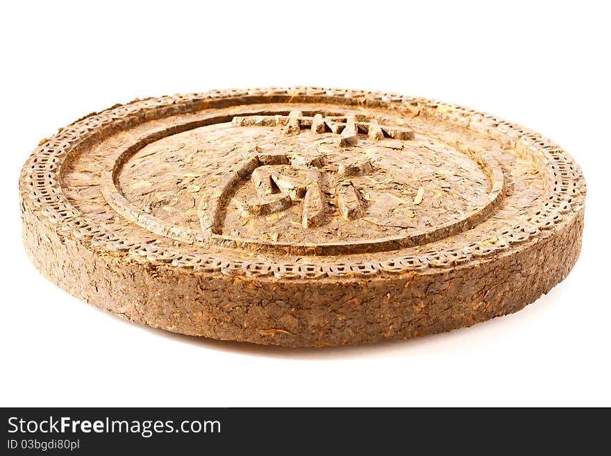 Dry Pressed Pu-erh tea is isolated on a white background