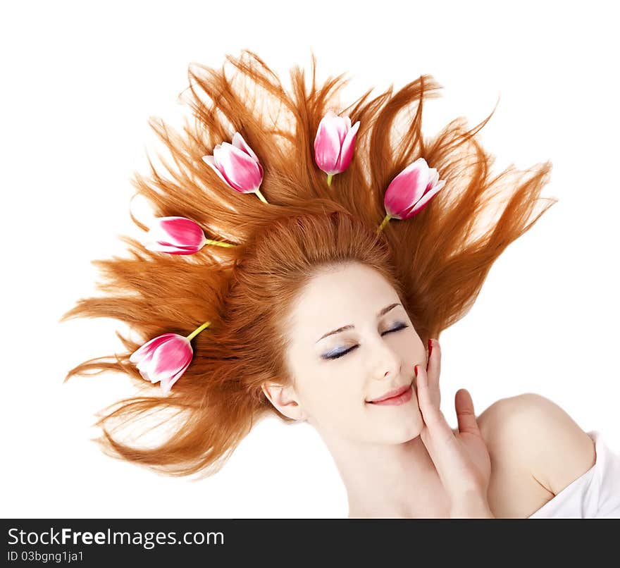 Beautiful red-haired girl with tulips. Studio shot.