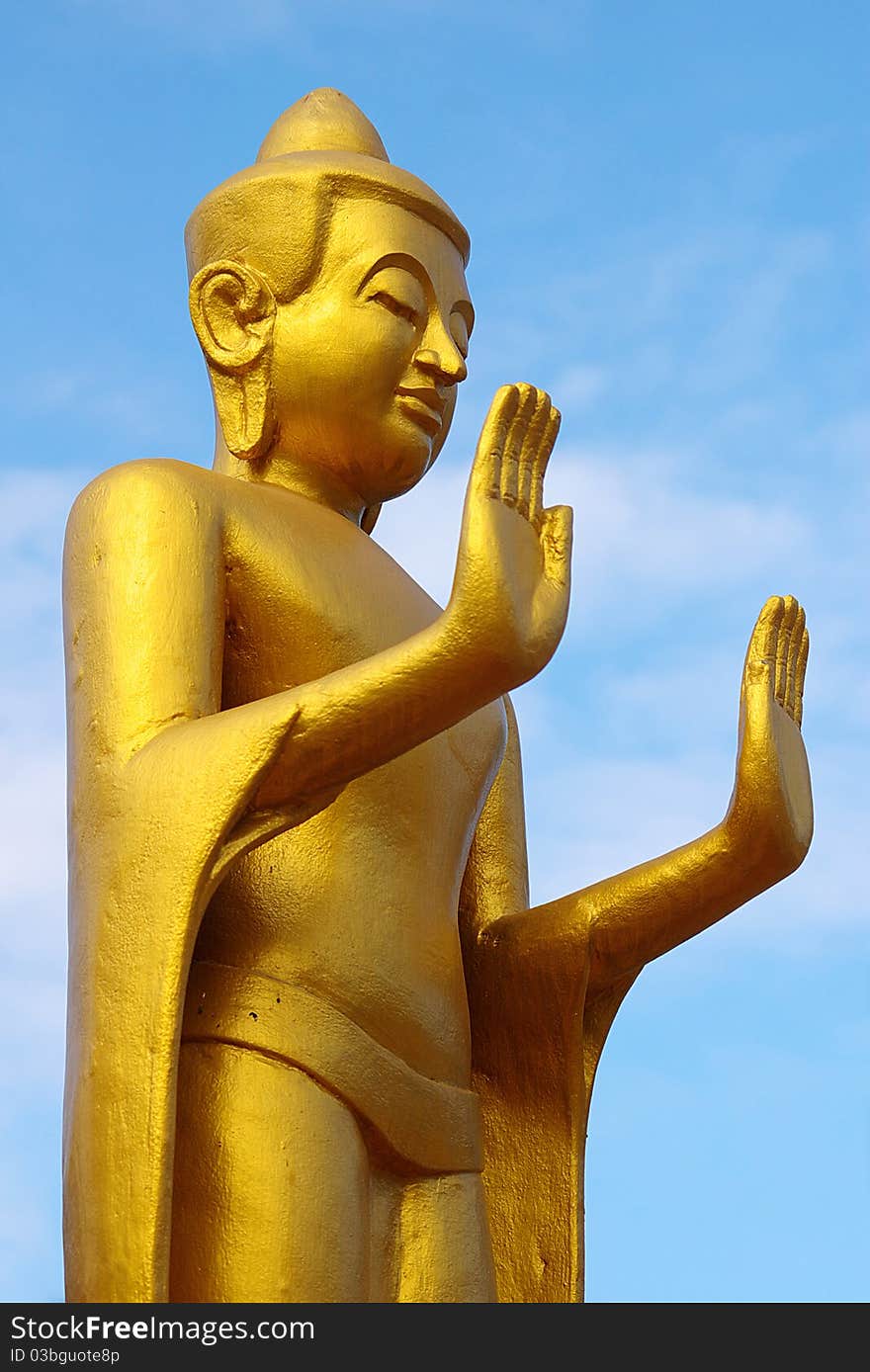 Statue of the Buddha on the background of the blue sky. Statue of the Buddha on the background of the blue sky