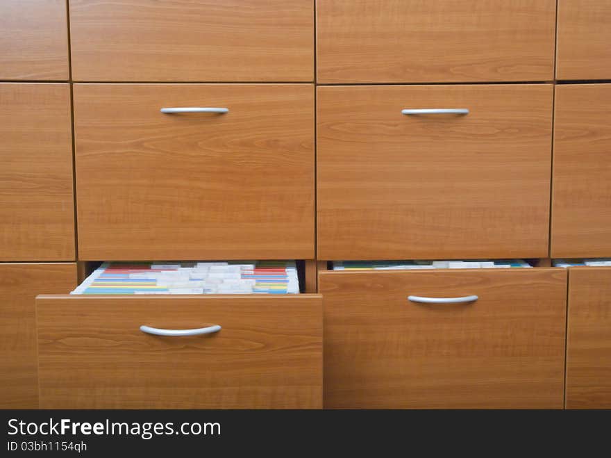 Open shelves made of wood with folders. Open shelves made of wood with folders