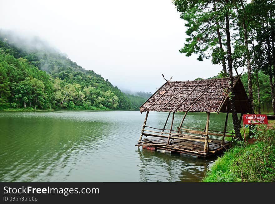 Old hut on the river with cloudy day