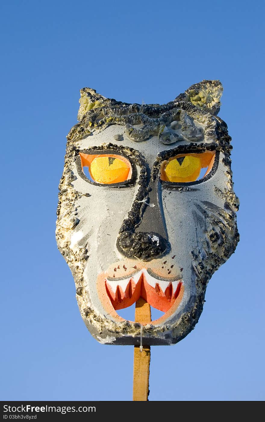 Spring feast Mardi Gras wolf mask on sky background