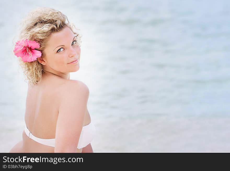 Attractive woman relaxing on sea background