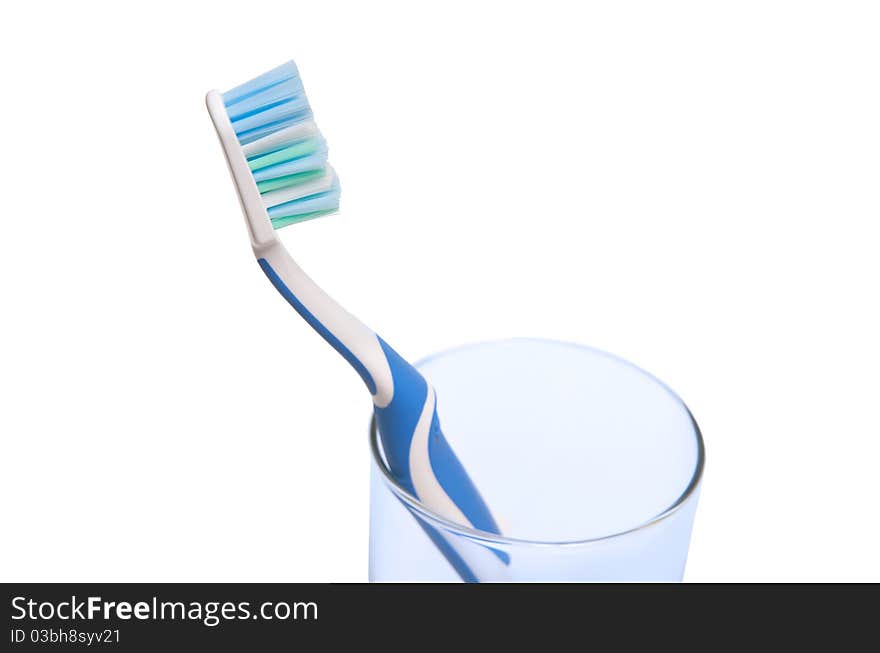 Toothbrush in glass isolated over white