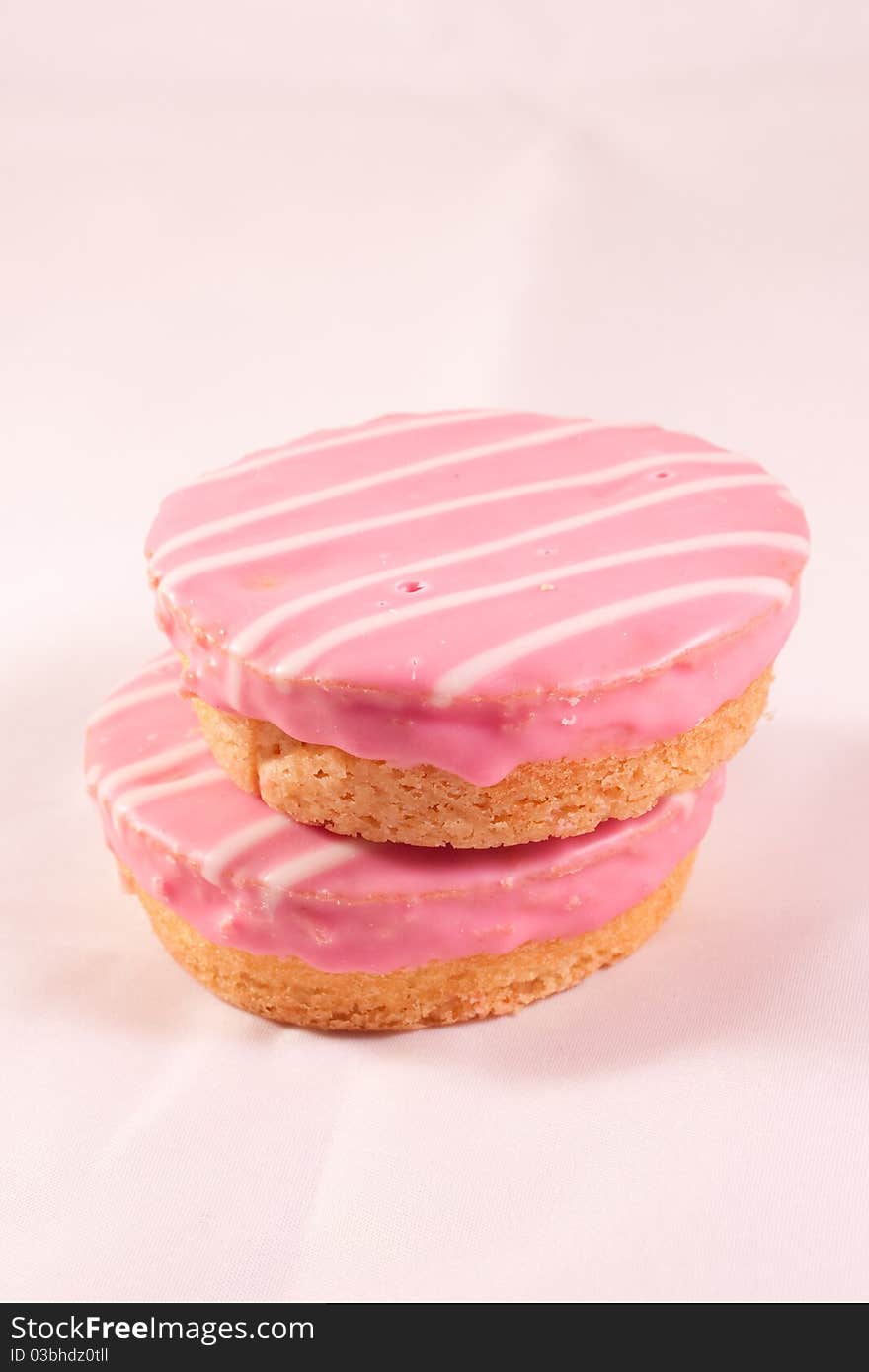 Small pink cakes on a white table