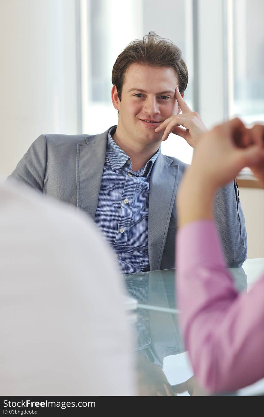 Young business man alone in conference room