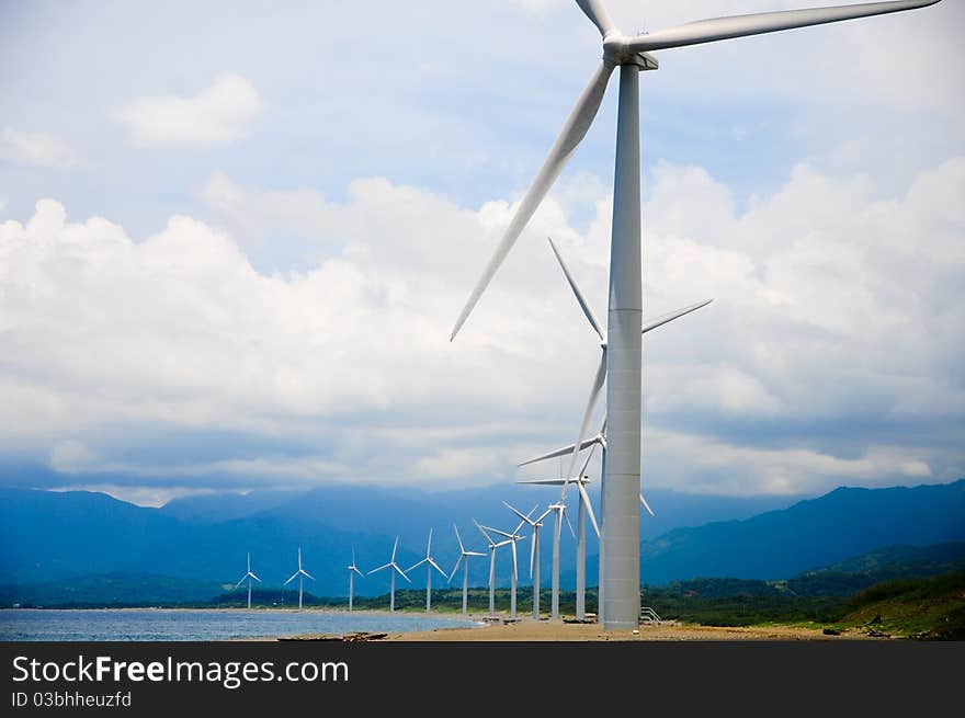 A row of Wind Turbine near the beach. A row of Wind Turbine near the beach.