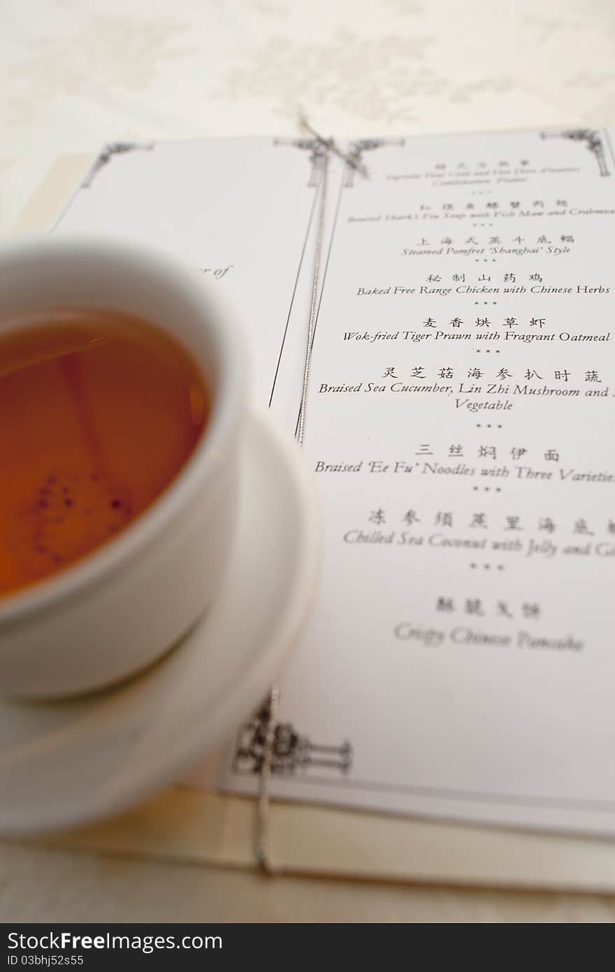 Chinese wedding menu with a chinese tea cup.