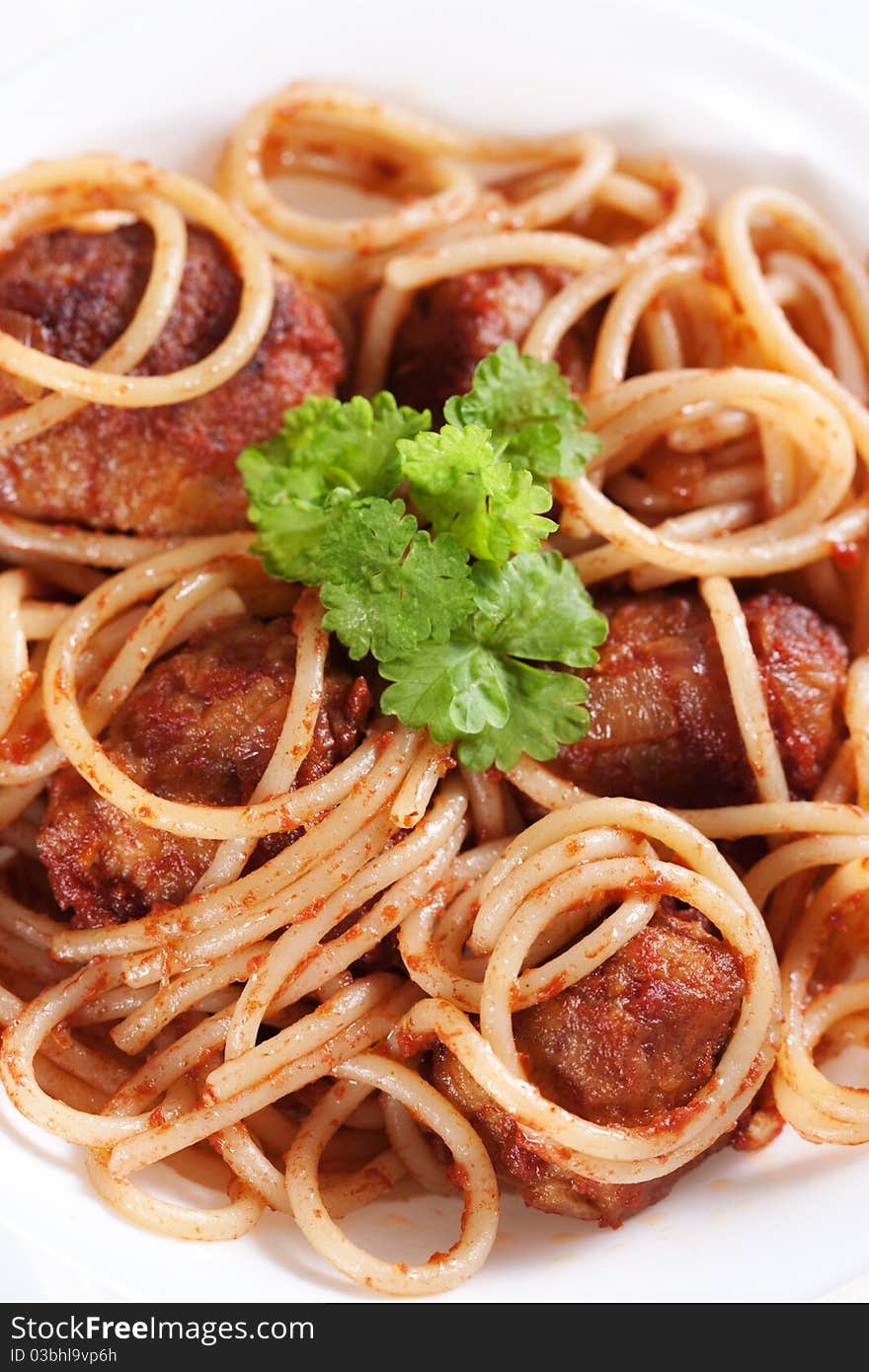 Pasta with meatballs and tomato sauce on white background