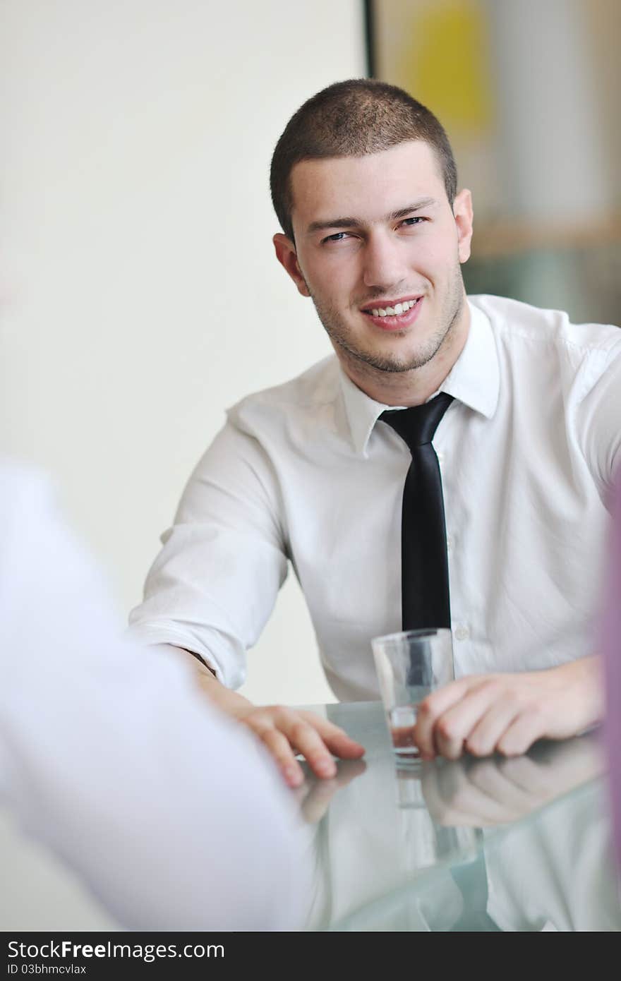 Young business man alone in conference room