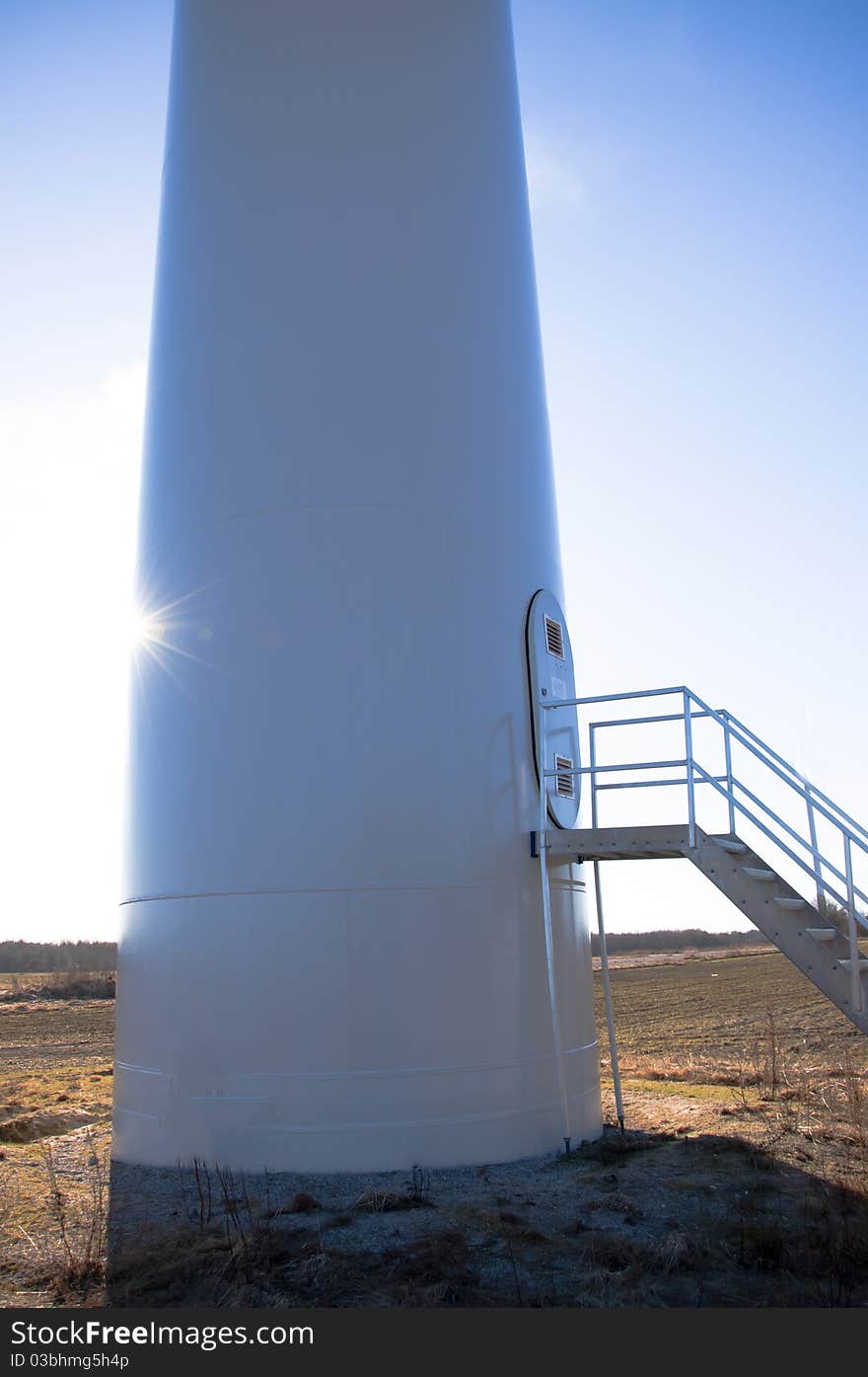 An image of wind turbine against blue sky