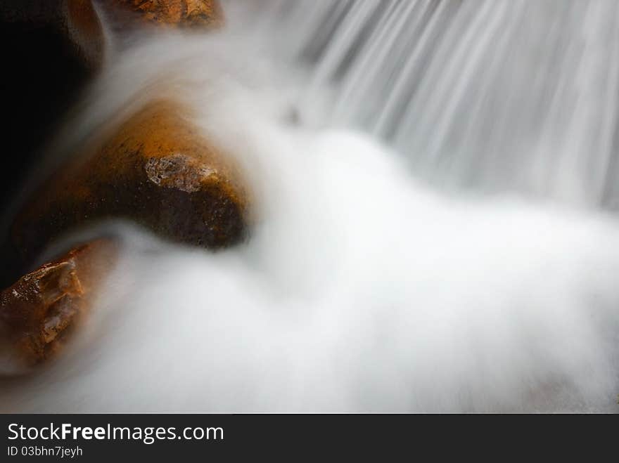 Rocks inside soft white water. Rocks inside soft white water