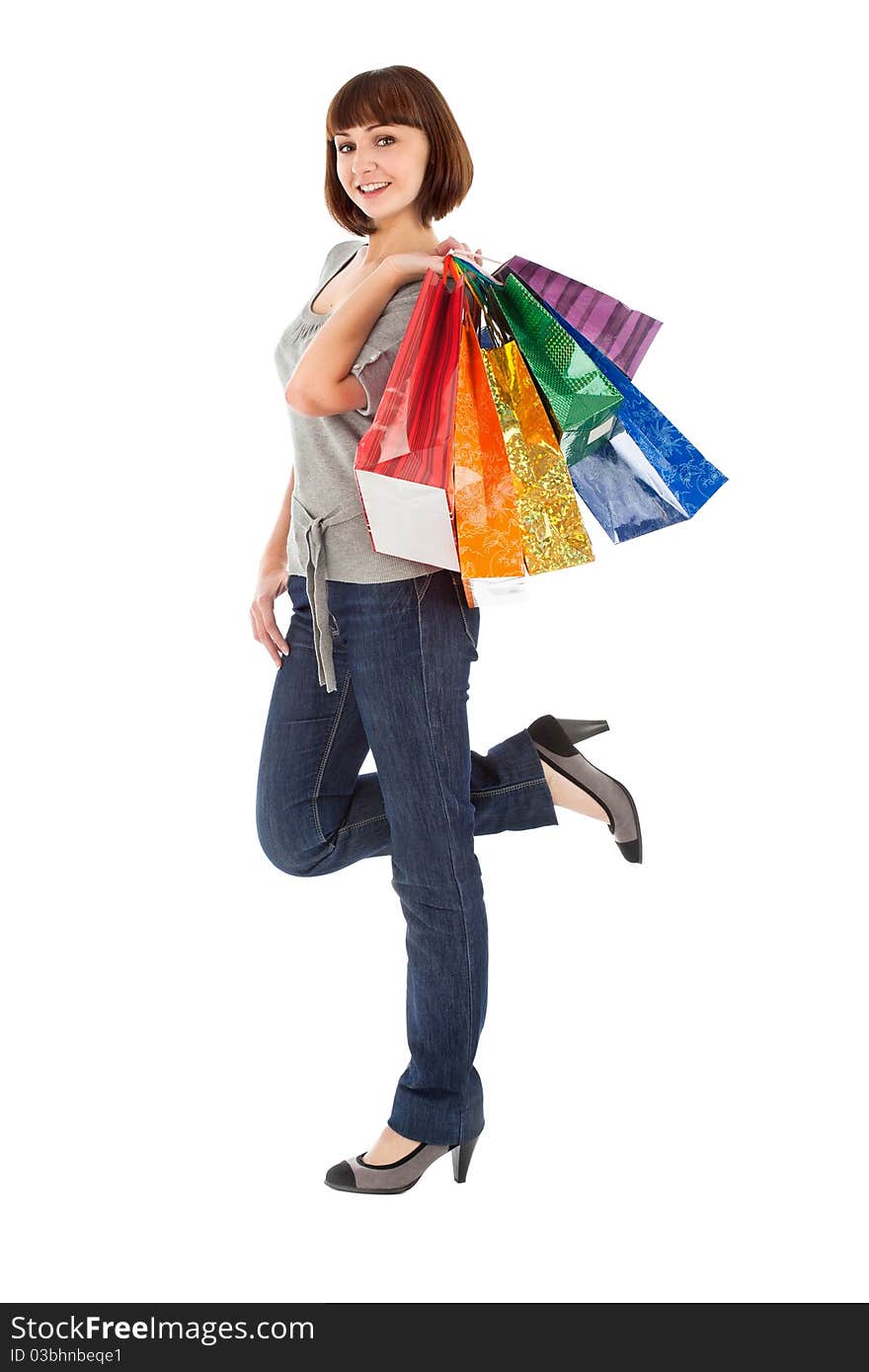 Woman with rainbow colored shopping bags