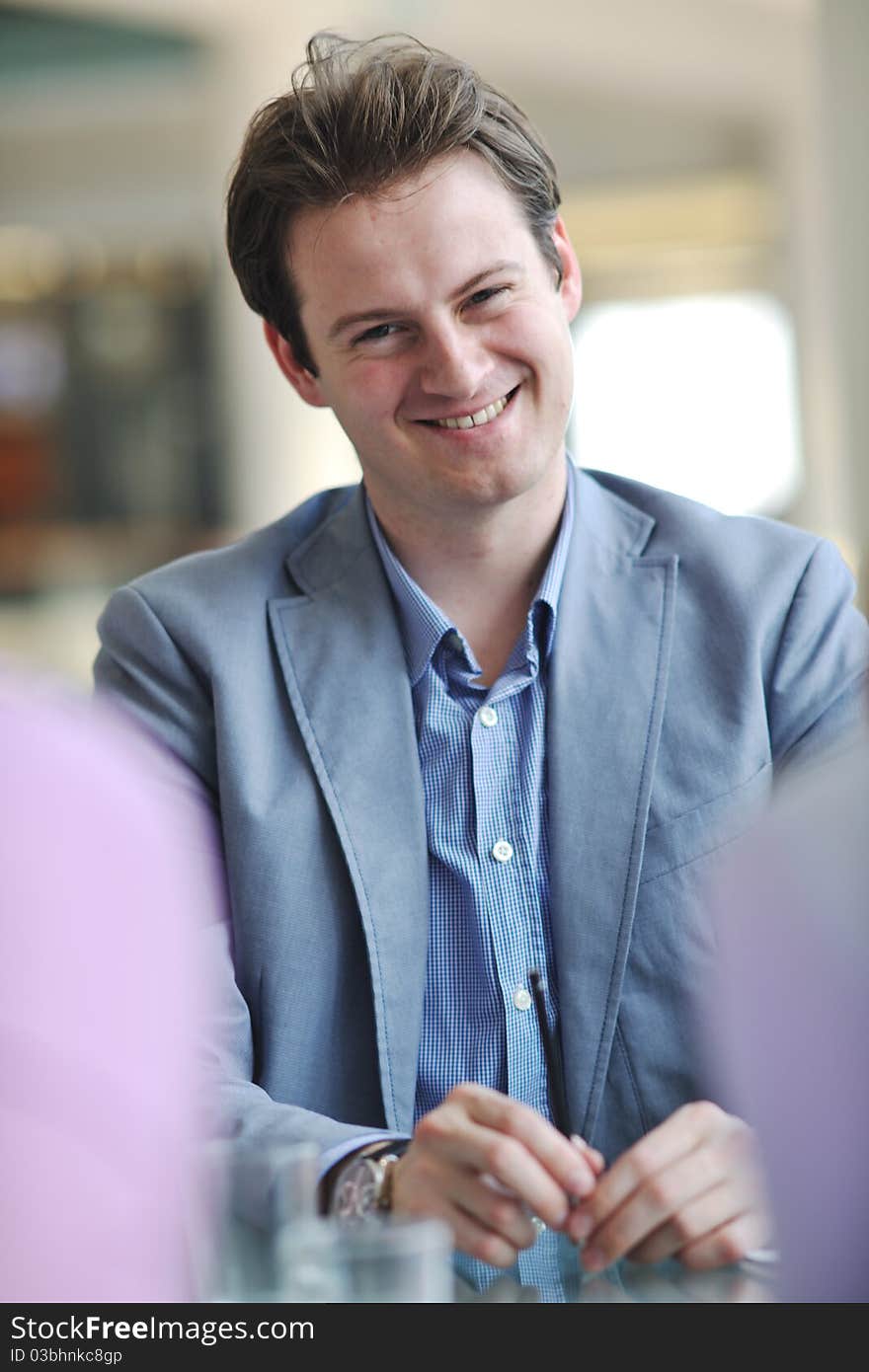 Young business man alone in conference room