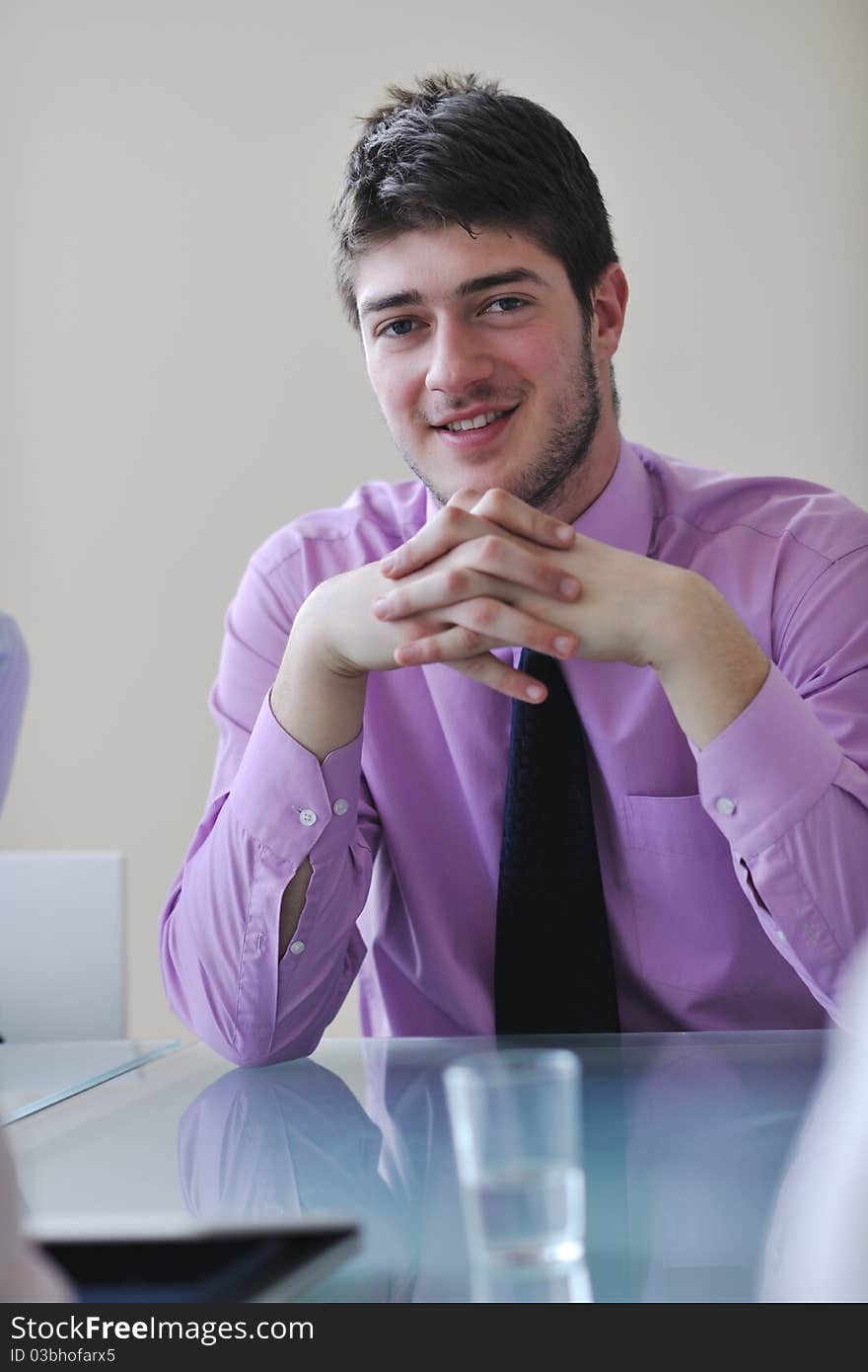 Young business man lawyer with laptop alone in big bright conference room. Young business man lawyer with laptop alone in big bright conference room