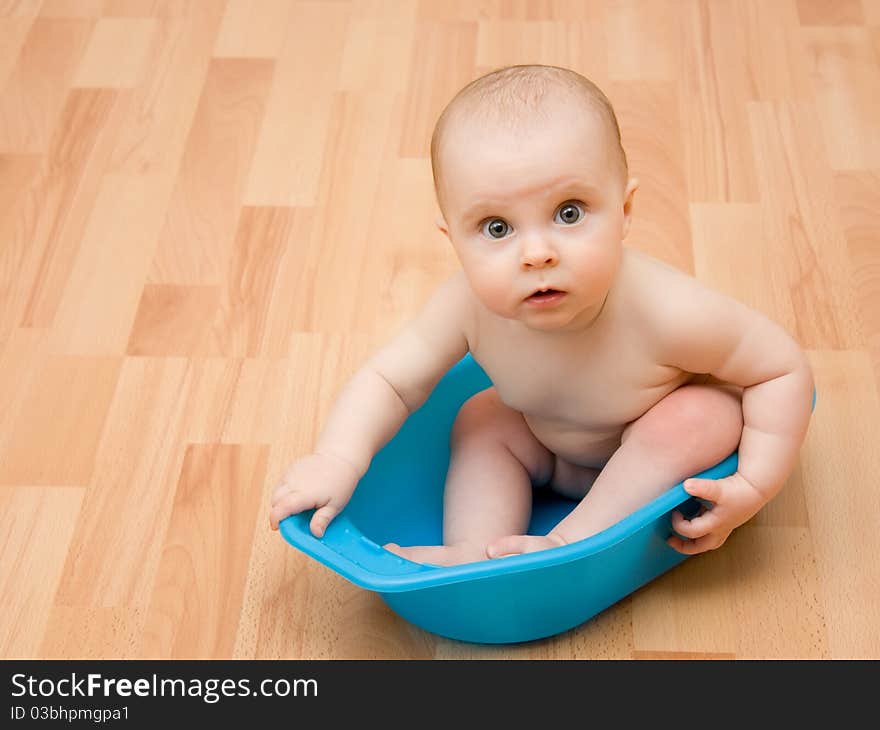 Surprised kid sitting in a bathtub. Surprised kid sitting in a bathtub.