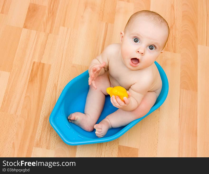 Surprised kid sitting in a bathtub. Surprised kid sitting in a bathtub.