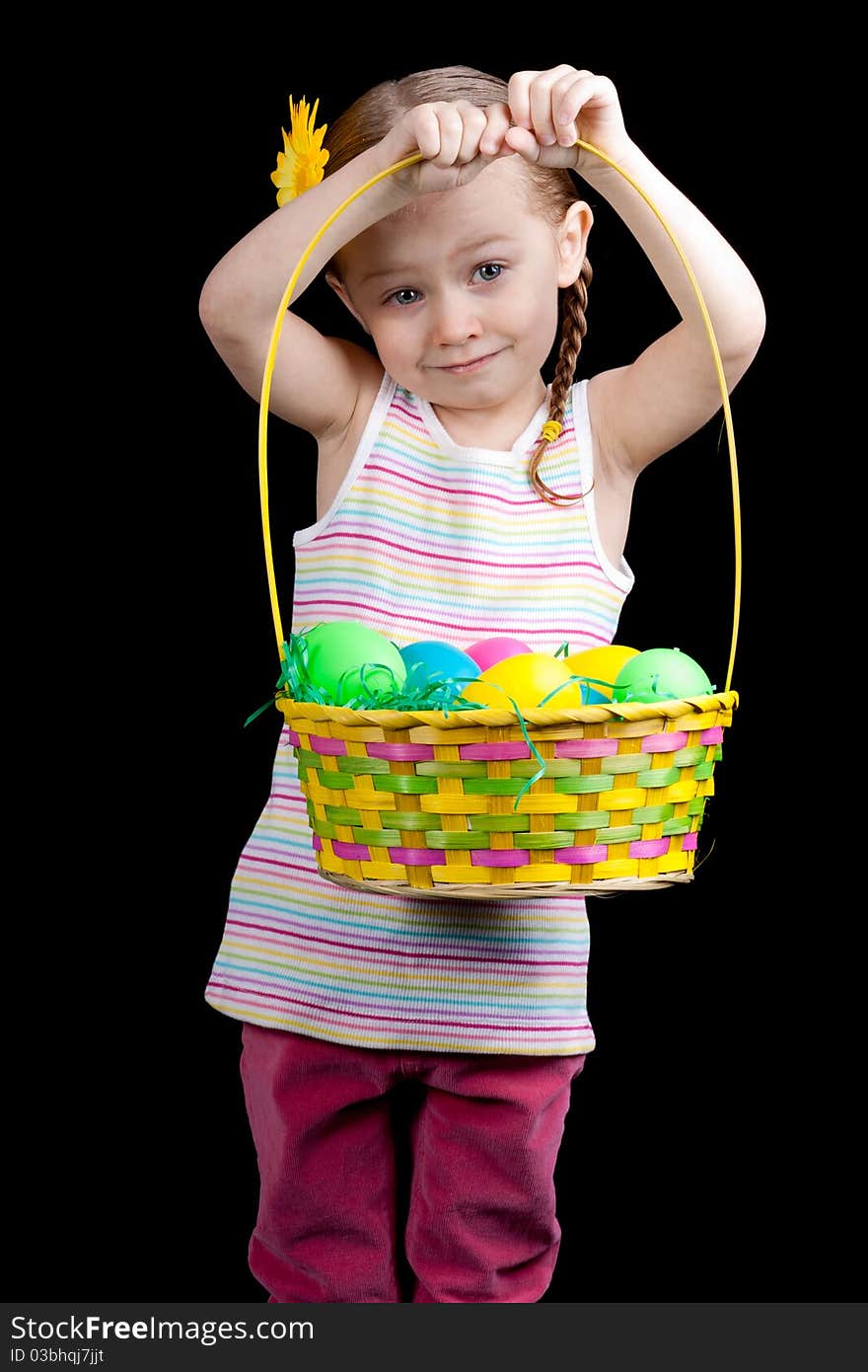 A cute girl holding up her colorful easter basket. A cute girl holding up her colorful easter basket.