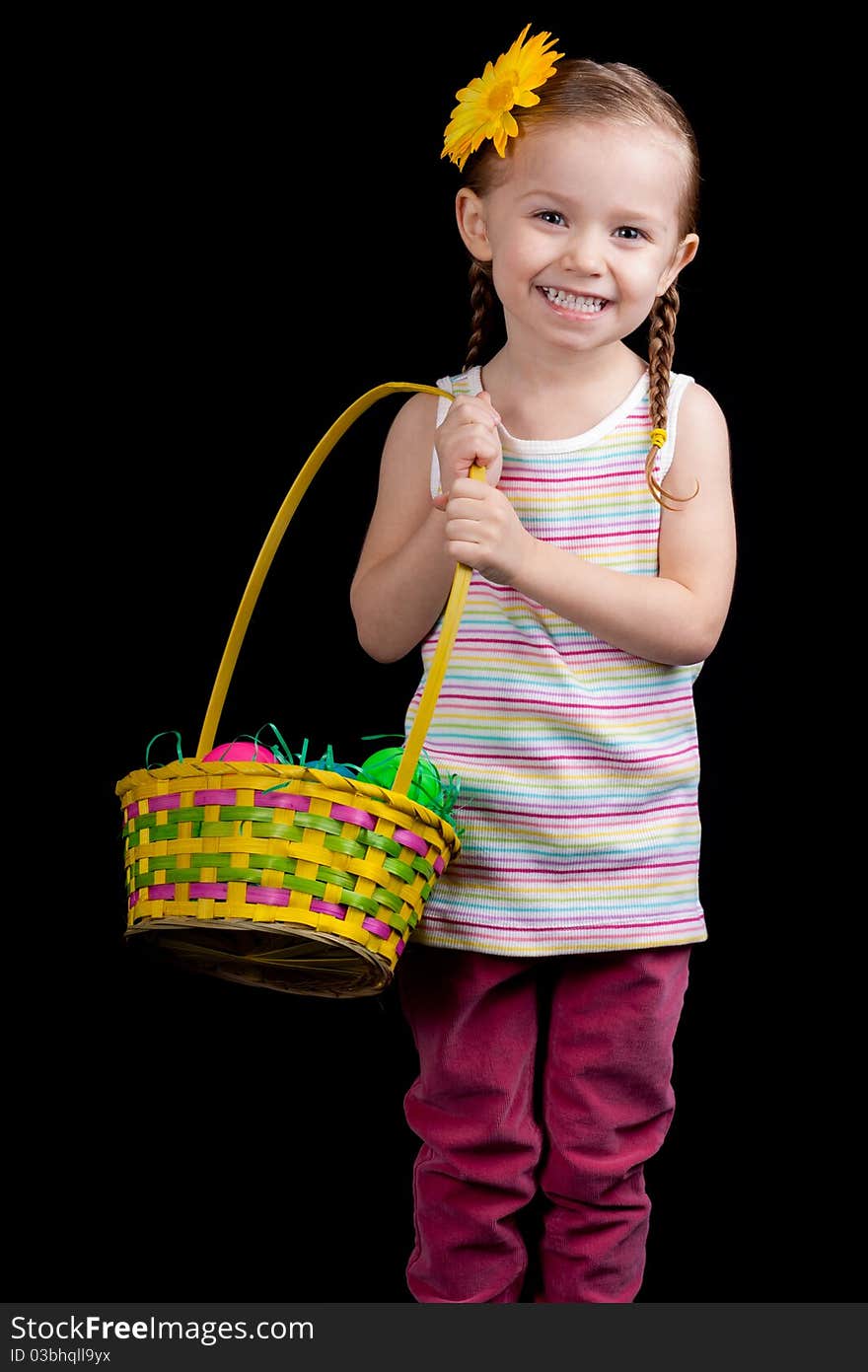 A happy young girl holding her easter basket. She is on the hunt for more eggs.