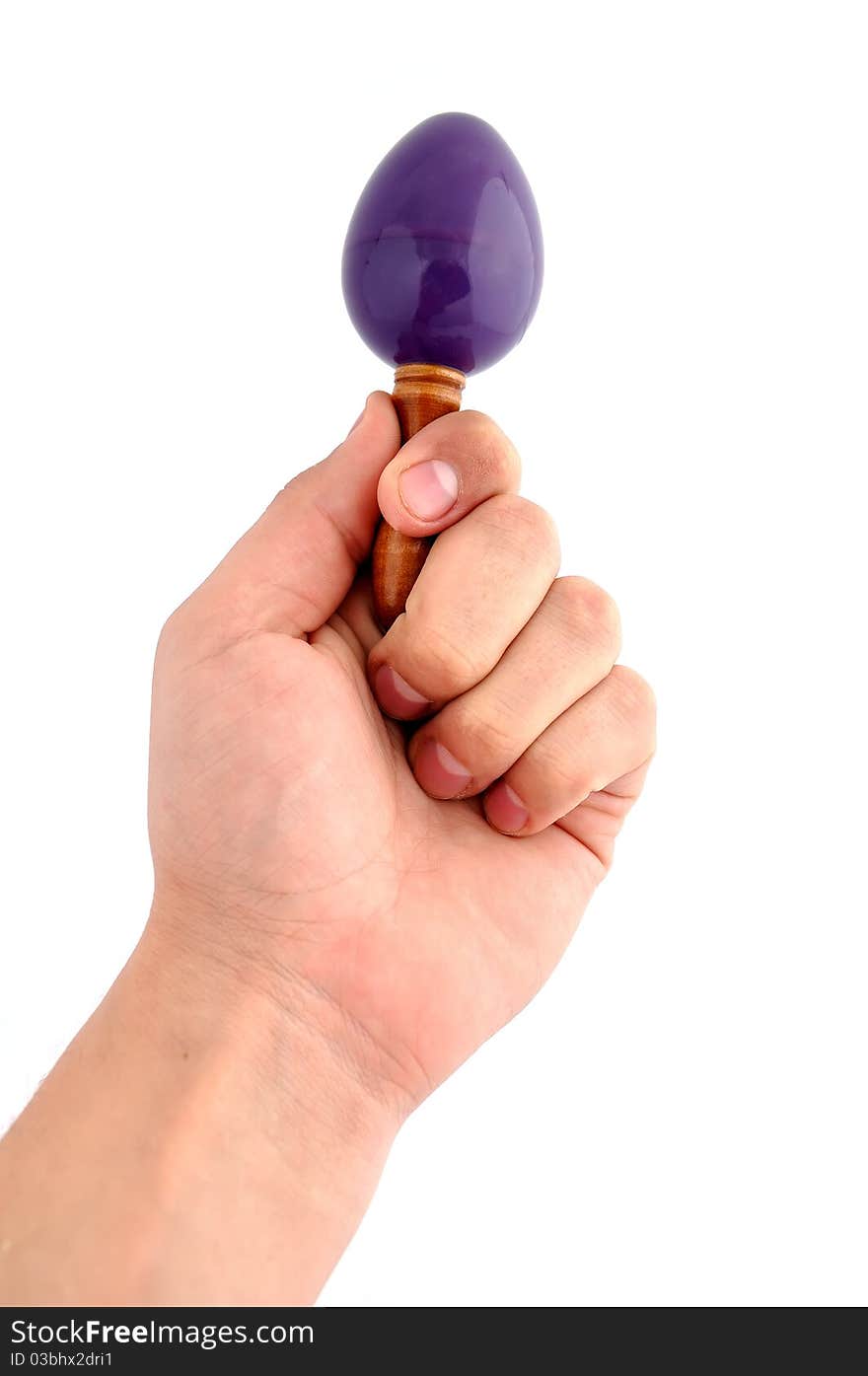 Maraca in hand on a white background