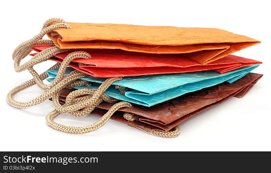 Four color paper bags isolated on the white background