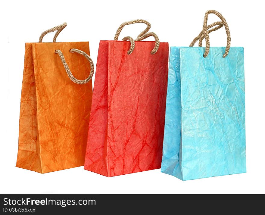 Three color paper bags isolated on the white background