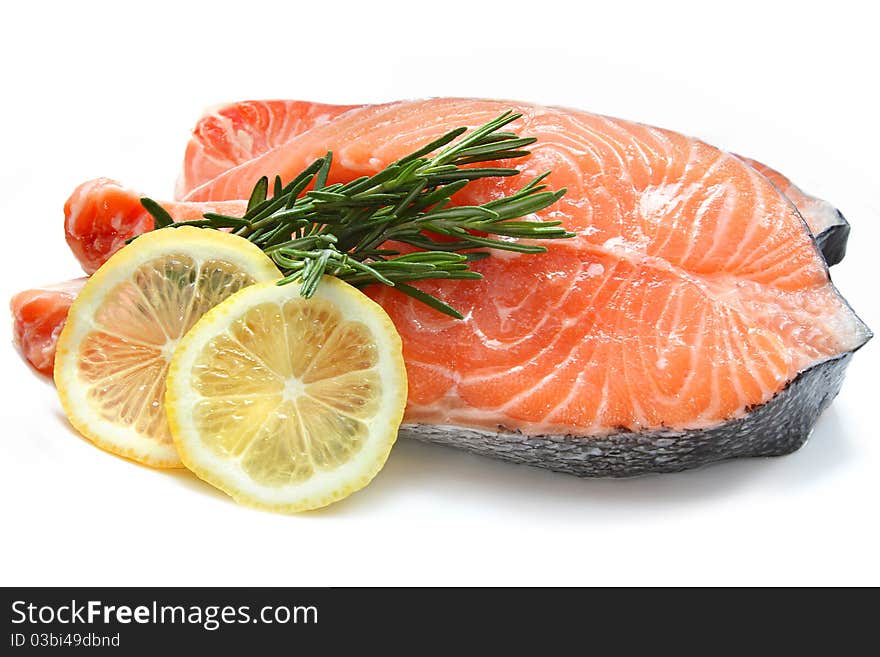 Raw fish meat with lemon and rosemary isolated on a white background. Raw fish meat with lemon and rosemary isolated on a white background