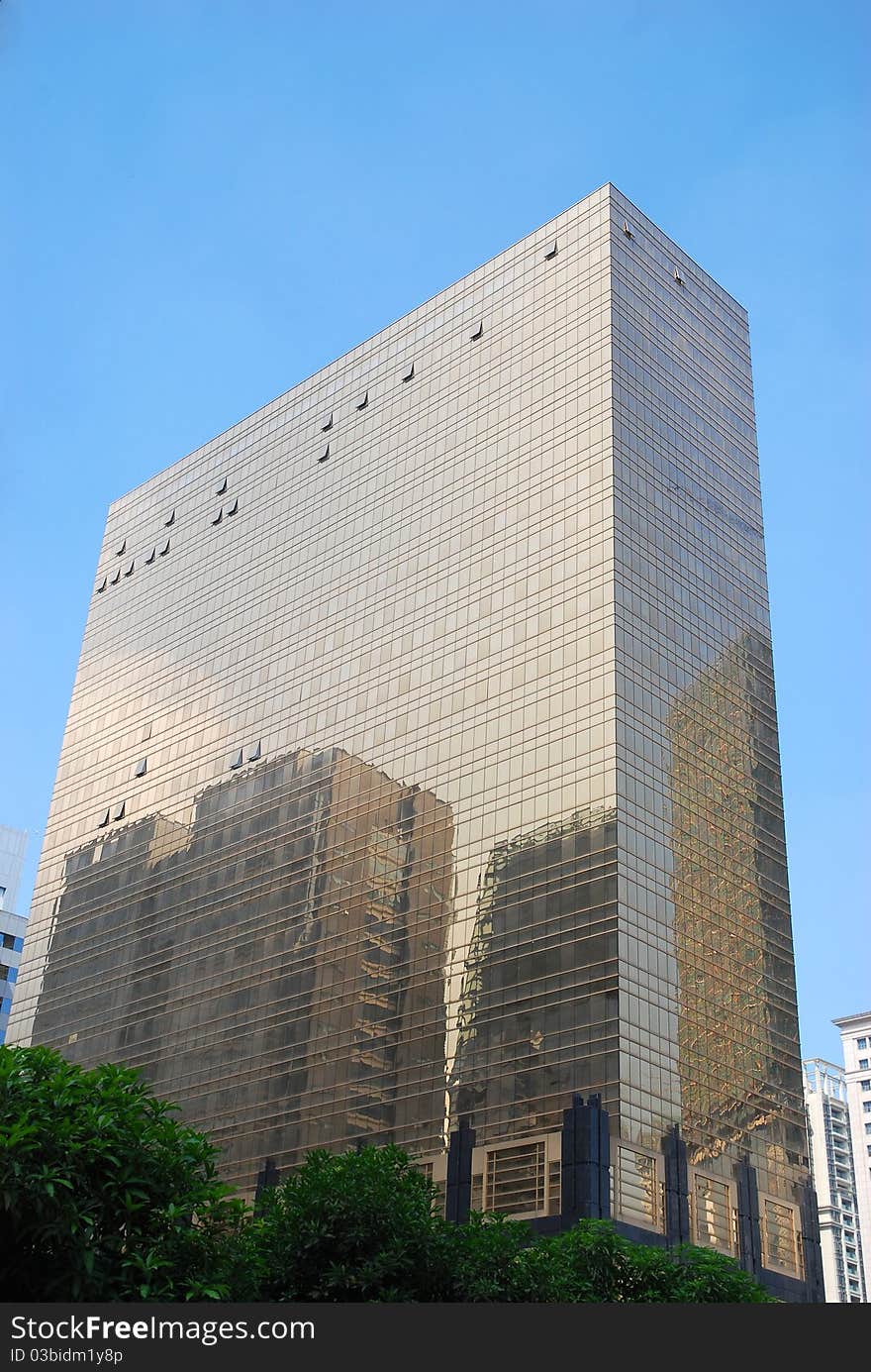 Golden office building with blue sky background in guangzhou city.