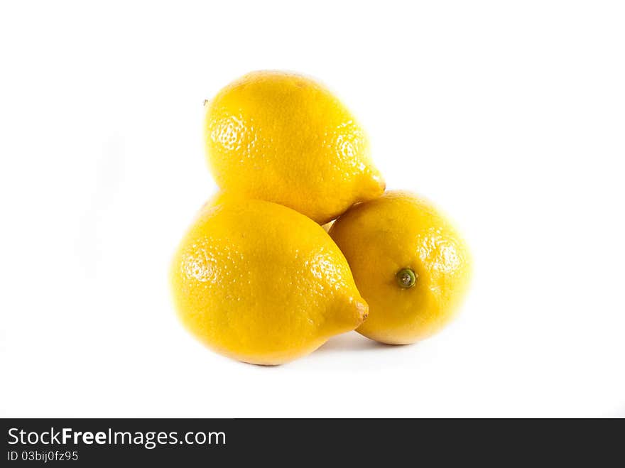 Four fresh yellow lemons stacked on a white isolated background. Four fresh yellow lemons stacked on a white isolated background.