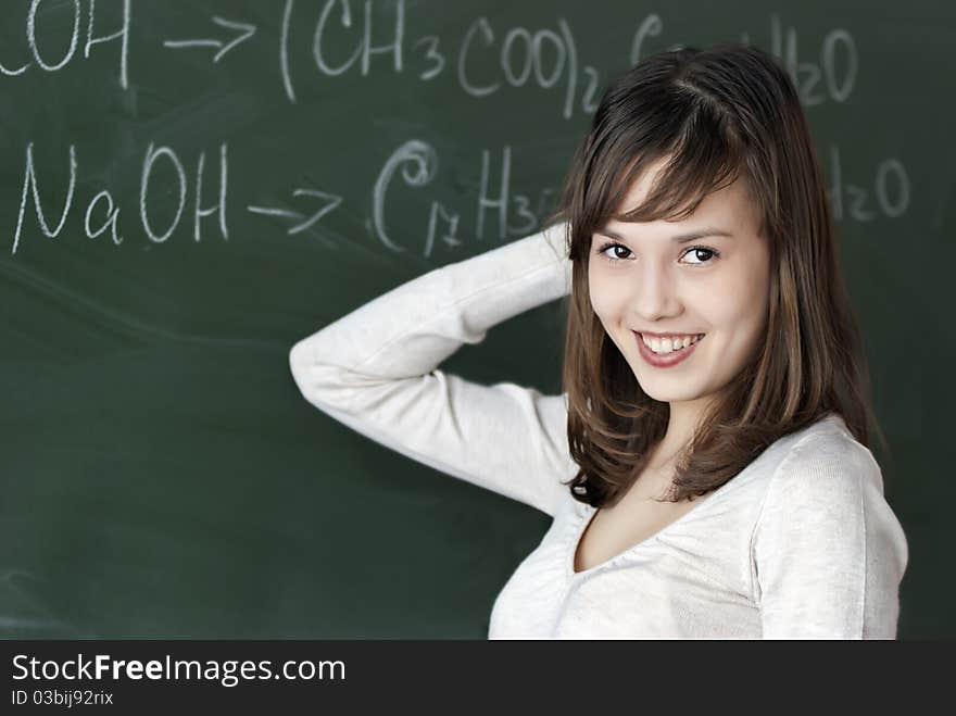 Teenage girl studying with textbooks