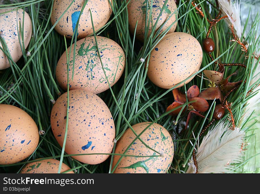 Easter wreath with eggs and decorations on green cloth