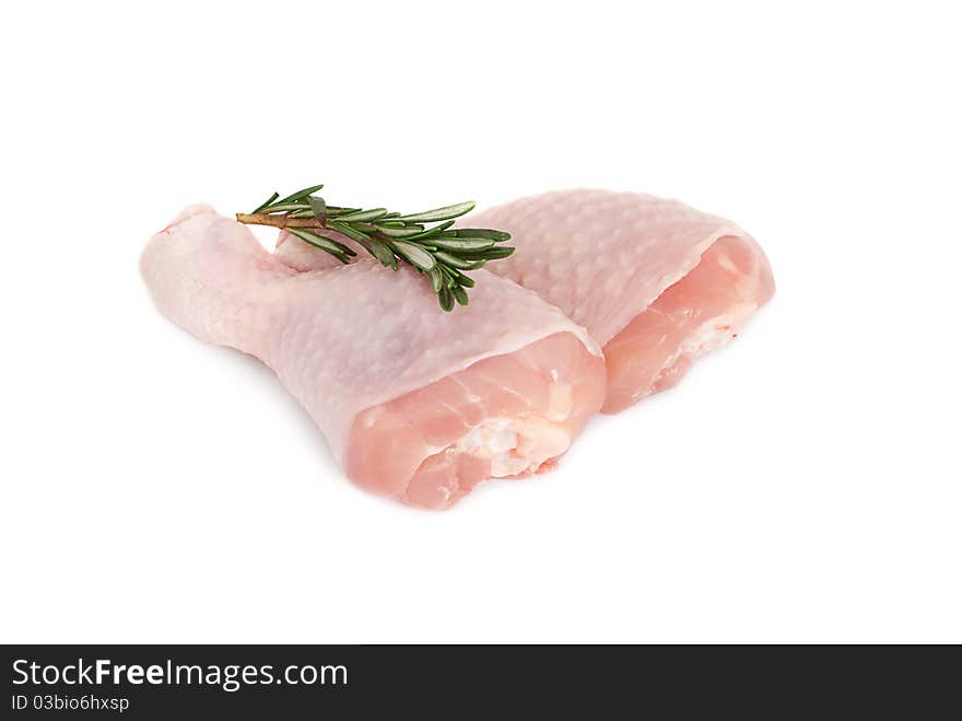 Two raw chicken drumsticks on a white background