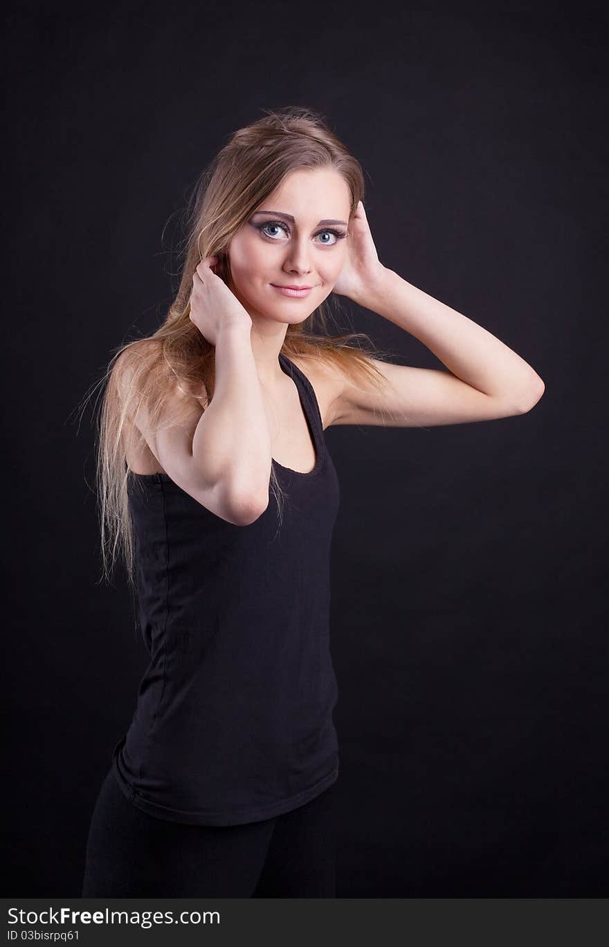 Young beauty blond girl in black tank top