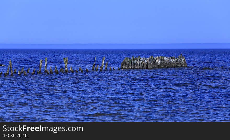 Old wooden pier in the sea.