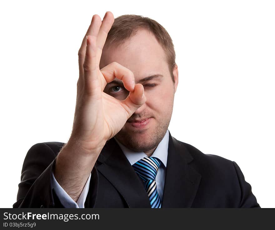 Unshaven businessman shows Ok on a white background