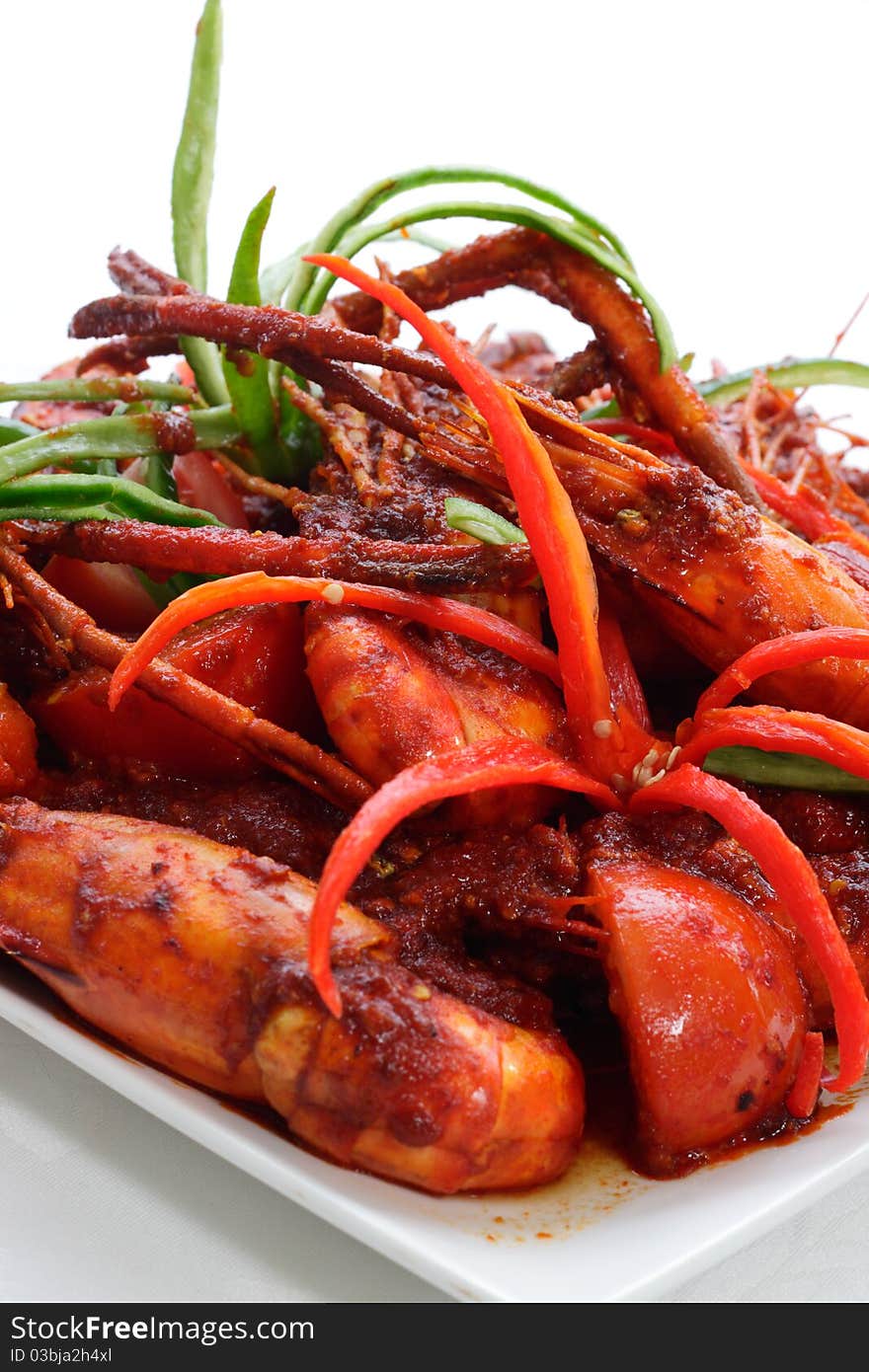 Close up of a plate of prawn cooked in sweet chili paste with garnishing. Close up of a plate of prawn cooked in sweet chili paste with garnishing