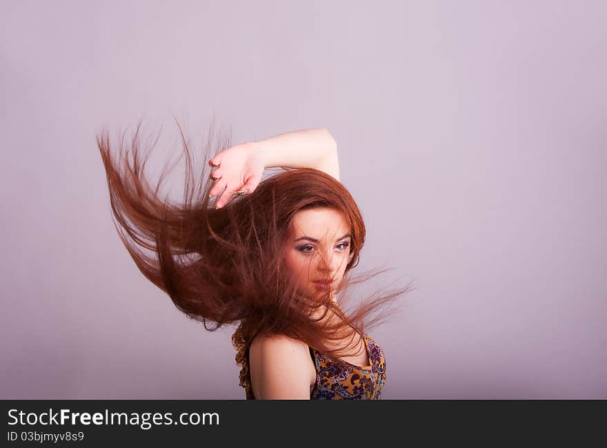 Portrait of a pretty  girl with hair fluttering in the wind. Portrait of a pretty  girl with hair fluttering in the wind