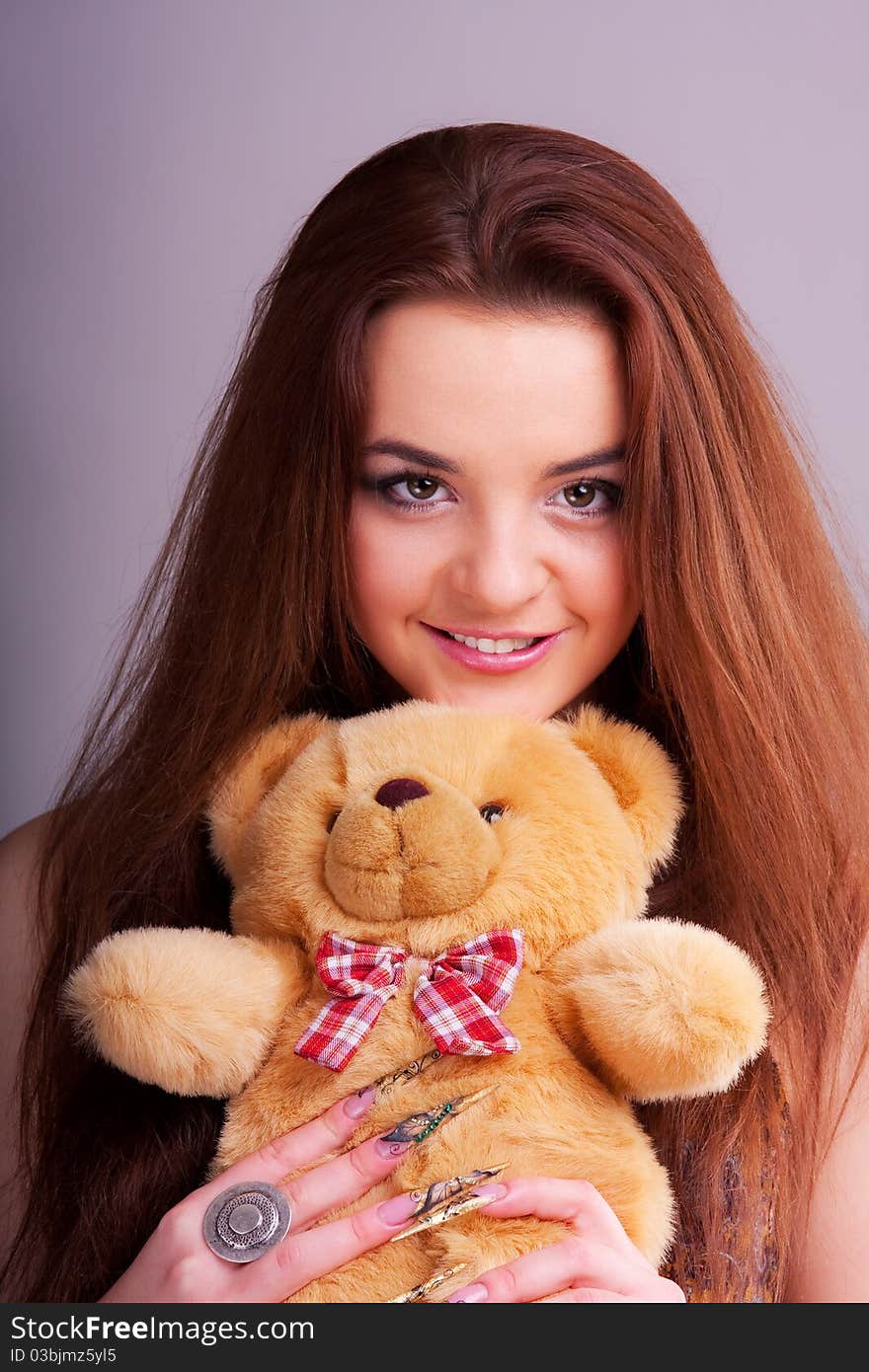 Beautiful longhair girl is holding the teddy bear. Beautiful longhair girl is holding the teddy bear