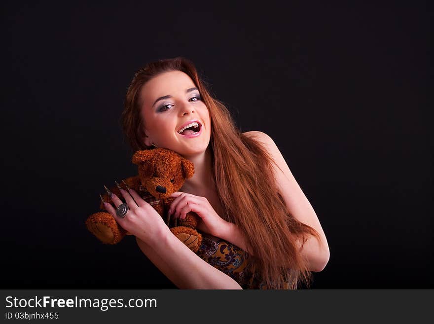 Beautiful longhair girl is holding the teddy bear. Beautiful longhair girl is holding the teddy bear