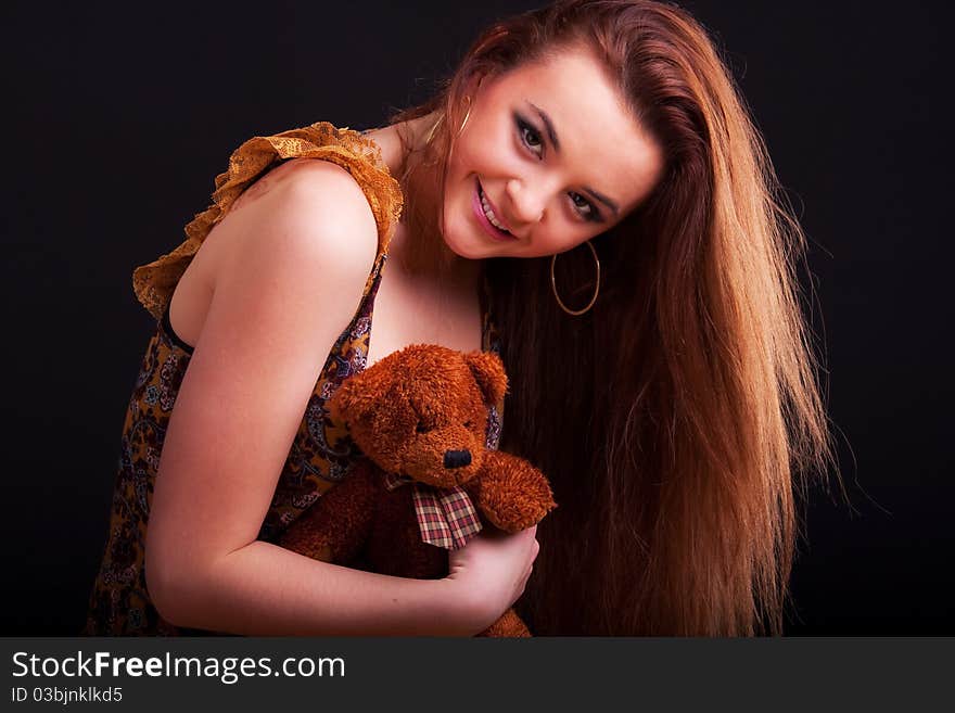 Beautiful longhair girl is holding the teddy bear. Beautiful longhair girl is holding the teddy bear