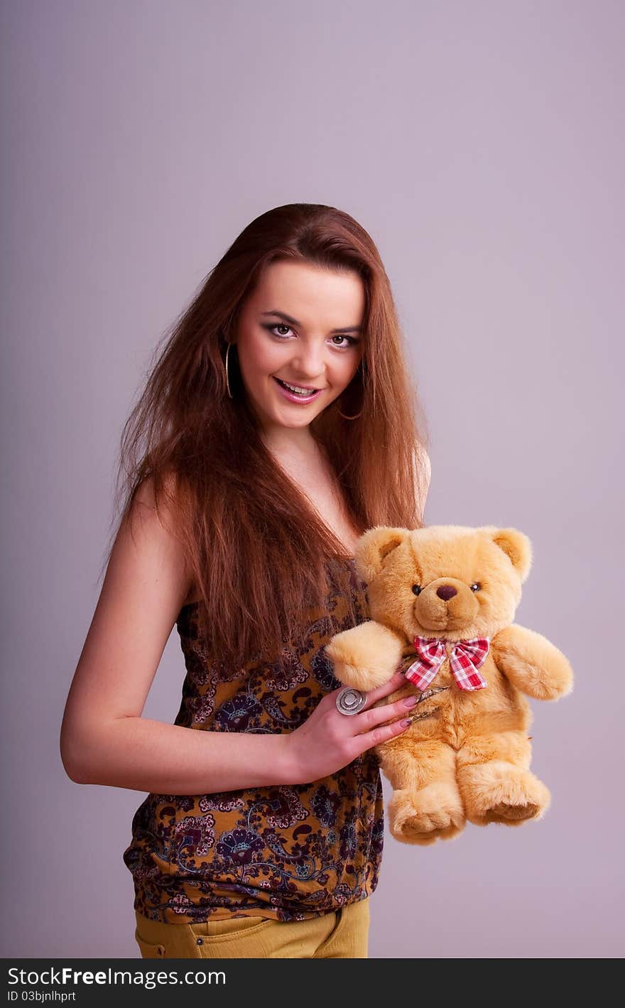 Beautiful longhair girl is holding the teddy bear. Beautiful longhair girl is holding the teddy bear